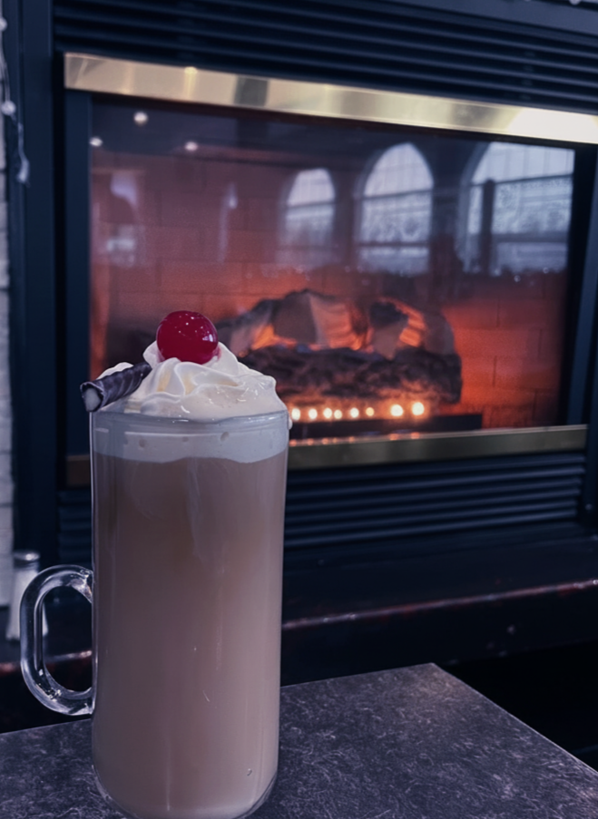 Signature cocktail by the fireplace at Gus' Bar & Grill